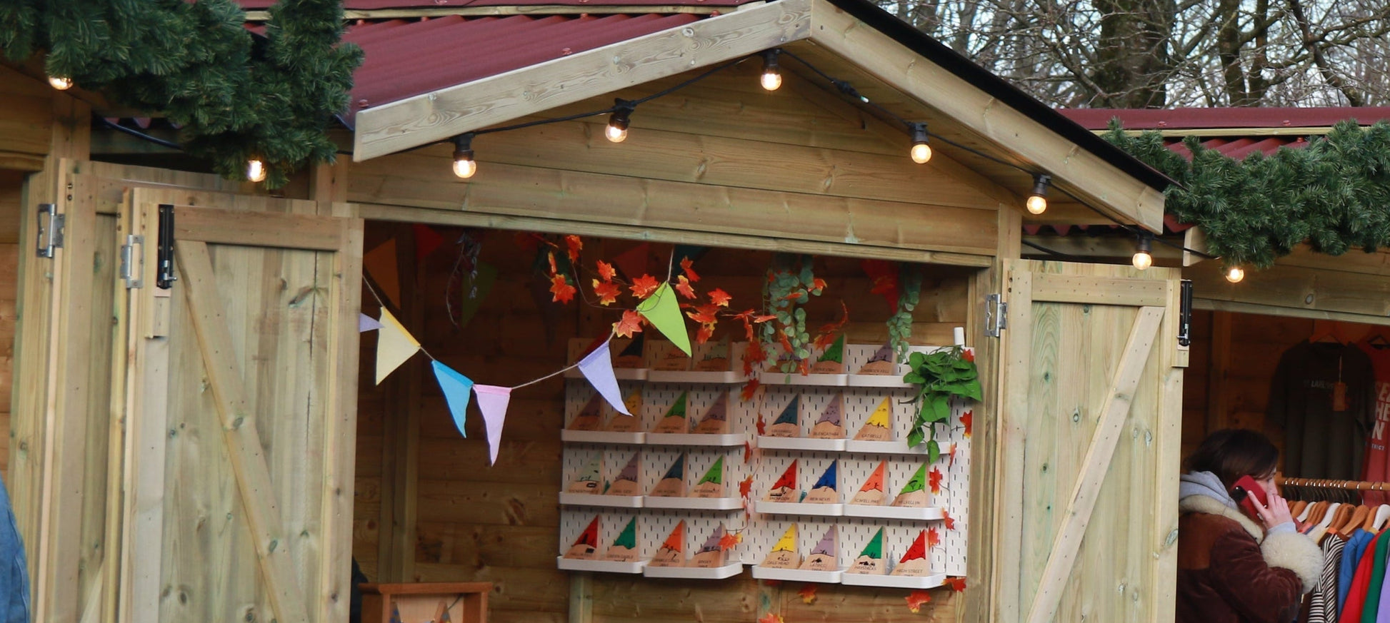 Wooden stalls with festive decorations at an outdoor market.